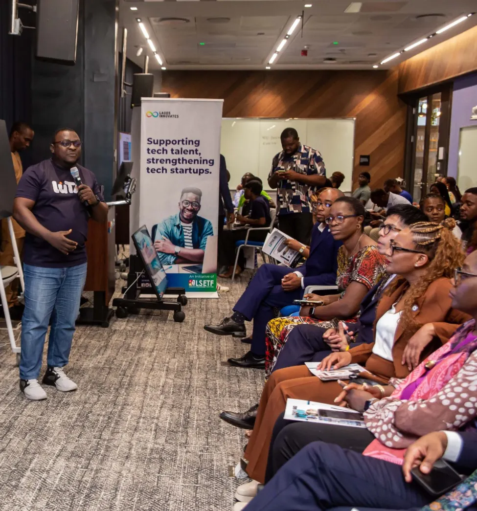 A speaker presenting to a full room at a tech community event in Lagos