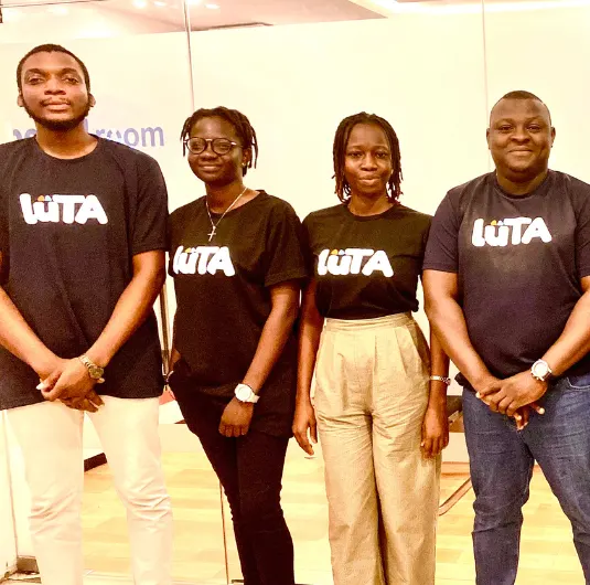 Four team members smiling at a startup event